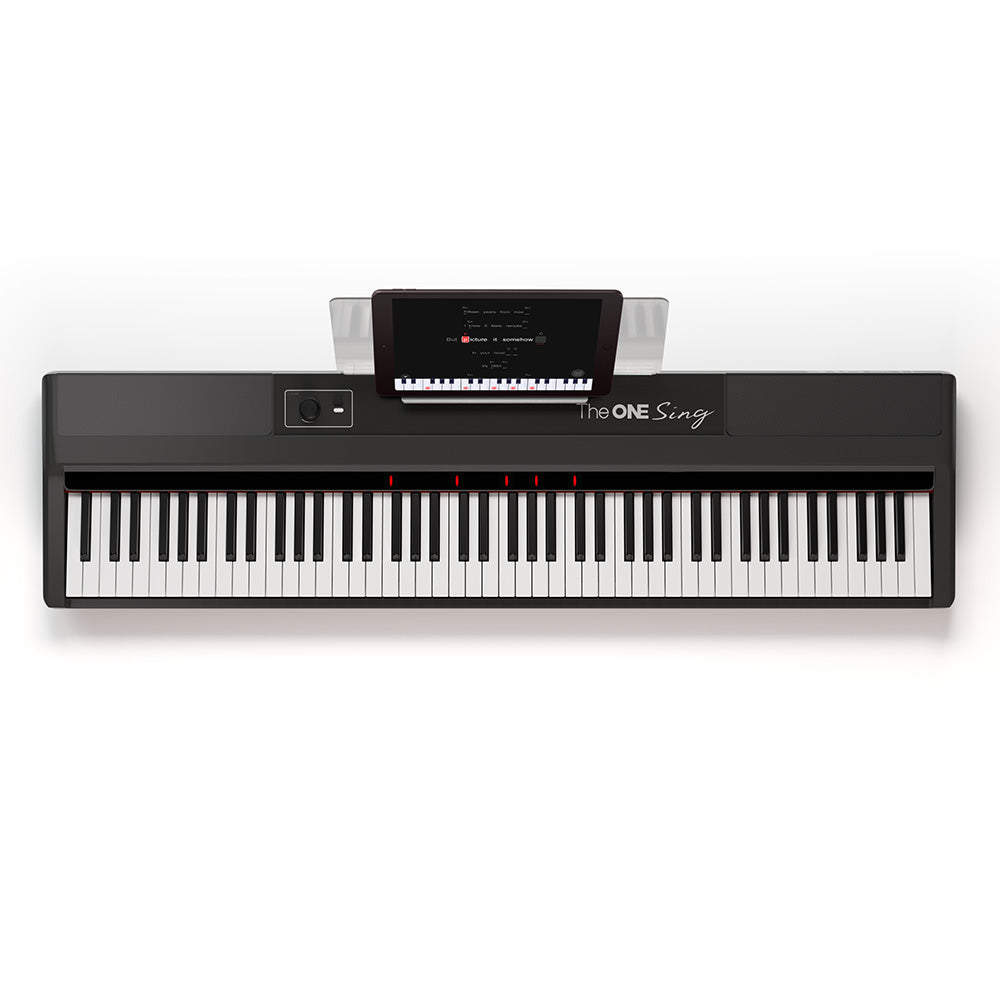 The ONE SING Pro piano beside a singing app interface